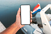 Man using smartphone on boat