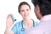 Doctor showing man inhaler