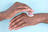 Woman applying hand cream