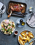 Slow-cooked lamb with garlic, cauliflower and lentil salad and potato wedges