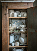 Vintage kitchen cupboard with crockery