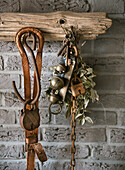 Antique locks, keys and leather straps on a rustic wooden beam in front of a brick wall