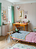 Children's room with wooden bed and colourful wall decoration