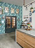 Modern kitchen with island, blue wallpaper and wall decoration