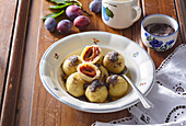 Potato dumplings with plums and poppy seed butter