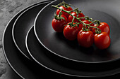 Cherry tomatoes on a black plate