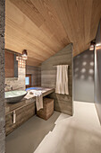 Modern bathroom with wooden ceiling and concrete walls