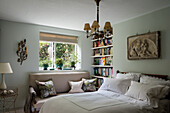 French country style bedroom with antique bench and floral cushions