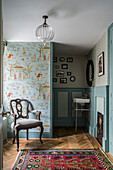 Vintage-style hallway with animal print wallpaper and oriental rug
