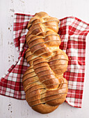 Yeast plait in slides on tea towel