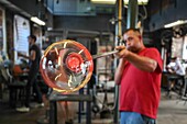 France,Moselle,Meisenthal,The International Glass Art Center (CIAV),Halle à chaud,The master glassmaker Jean Marc Schilt blowing glass