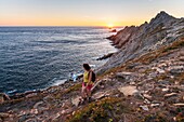 France,Finistere,Plogoff,hiker at sunset at Pointe du Raz