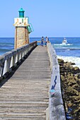 France,Landes,Capbreton,boom and lighthouse on the Atlantic coast with a fishing boat going off