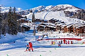 France,Savoie,Valmorel,Tarentaise valley,massif of the Vanoise,view of the Cheval Noir (2832m) and the chairlift the Altispace since the kindergarten