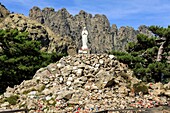 France,Corse du Sud,Quenza,Col de Bavella,Our Lady of the Snow,white virgin of Alta Rocca,Needles of Bavella in the background