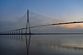 France,between Calvados and Seine Maritime,the Pont de Normandie (Normandy Bridge) in the mists of dawn,it spans the Seine to connect the towns of Honfleur and Le Havre