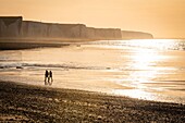 France,Somme,Bay of Somme,Picardy Coast,Ault,Walkers on beach at the foot of the cliffs