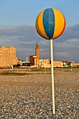 France,Seine Maritime,Le Havre,city rebuilt by Auguste Perret listed as World Heritage by UNESCO,pebble beach and its cabins with at the bottom the bell tower of the church of Saint Joseph