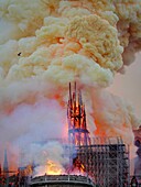 [ Unpublished - Exclusive ] France,Paris,area listed as World Heritage by UNESCO,Notre Dame Cathedral of 14th century Gothic architecture during the fire of 15th April 2019,close-up of the broken spire