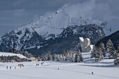 France,Haute Savoie,Bornes massif,Glieres plateau,skating skiers on cross country ski trails and the national monument of the resistance of Emile Gilioli and the peak of Jalouvre