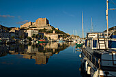 The citadel rises above the harbour of Bonifacio. Corsica. France