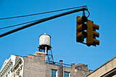 Traditional Water Deposit And Traffic Light In Manhattan,New York,Usa