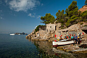 Spain,Ibiza,Fishermen preparing their boat,Cala d'Hort beach