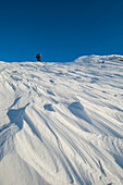 UK,Scotland,Man going through snow up Beinn Respiol on Ardnamurchan peninsula,Highlands