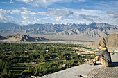 Tourists looking out from the Shanti (Peace) Stupa in Changspa looking over Leh. Leh was the capital of the Himalayan kingdom of Ladakh,now the Leh District in the state of Jammu and Kashmir,India. Leh is at an altitude of 3,500 meters (11,483 ft).