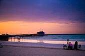 UAE,People watching sunset on Jumeirah Beach,Dubai