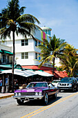 USA.,Florida,Miami,Ocean Drive,South Beach,bright purple colored 70s Chevrolet muscle car,All american