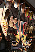 Lederschuhe und andere touristische Waren zum Verkauf in diesem Geschäft in der Nähe des Hawa Mahal City Palace, Jaipurs Wahrzeichen, Jaipur, Rajasthan State, Indien.