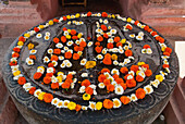 India,Bihar,Feet of Buddha covered with flowers outside Mahabodhi Temple,Bodhgaya