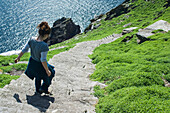 UK,Ireland,County Kerry,Skellig Islands,Hiker on footpath climbing up Skellig Michael