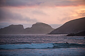 UK,Ireland,County Kerry,Iveragh Peninsula,Saint Finan's Bay,Surfers at sunset