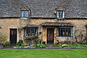 UK,Cotswolds,Cottages on High Street. Limestone buildings. Rainy day. Broadway,Western Cotswolds
