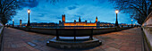 UK,Panoramic view of bench overlooking Houses of Parliament on River Thames at dusk,London