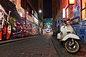 Australia,Victoria,View of street Art and moped on Hosier Lane with Federation Square in background,Melbourne