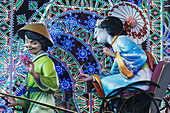 Detail Of Large Falla Of Japanese Lady Being Pulled On Rickshaw By Man Displayed On Street As Part Of Fallas Festival,Valencia,Spain