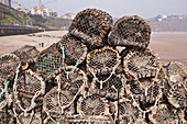 Lobster Pots At Harbor With North Beach In Background,Tenby,Pembrokeshire Coast Path,Wales,Vereinigtes Königreich