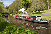 Tourist Boat Passing Narrowboat Moored On Kennet And Avon Canal,Wiltshire,England