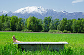 Feet Sticking Out Of A Bathtub In The Middle Of A Field With The Mountains Of The Swiss Alps In The Background,Locarno,Ticino,Switzerland