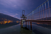 A Diving Board On The Edge Of Tranquil Lake Maggiore At Nighttime,Ascona,Ticino,Switzerland