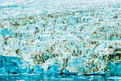 Lines and patterns of an iceberg with blue ice reflecting in water,Antarctica