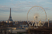 Ferris wheel and the Eiffel Tower adorn the skyline in downtown Paris,France,Paris,France