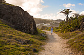 Scenic view of a woman walking on a seaside path at Bathsheba,Bathsheba,Barbados,Caribbean