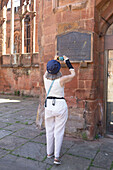 Mature woman uses her smart phone while exploring a historic site,United Kingdom