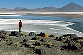 Figure in red on the edge of a seasonal lake in the Atacama desert,Chile