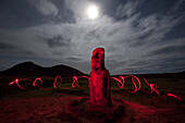 Moai at night beneath the light of the moon and surrounded by swirling hand held lights on Easter Island at Tongariki site,Chile,Easter Island,Isla de Pascua,Chile