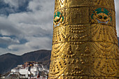 Porta Potola Palace past the giant prayer wheel atop the Jokhang temple,Lhasa,Tibet